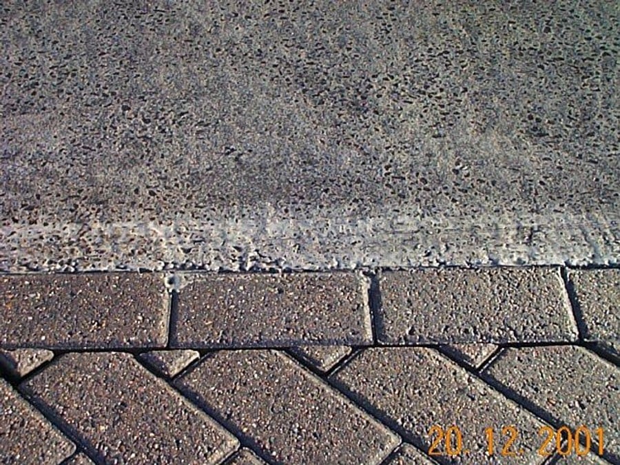 The new surface course tying in to the existing block paving