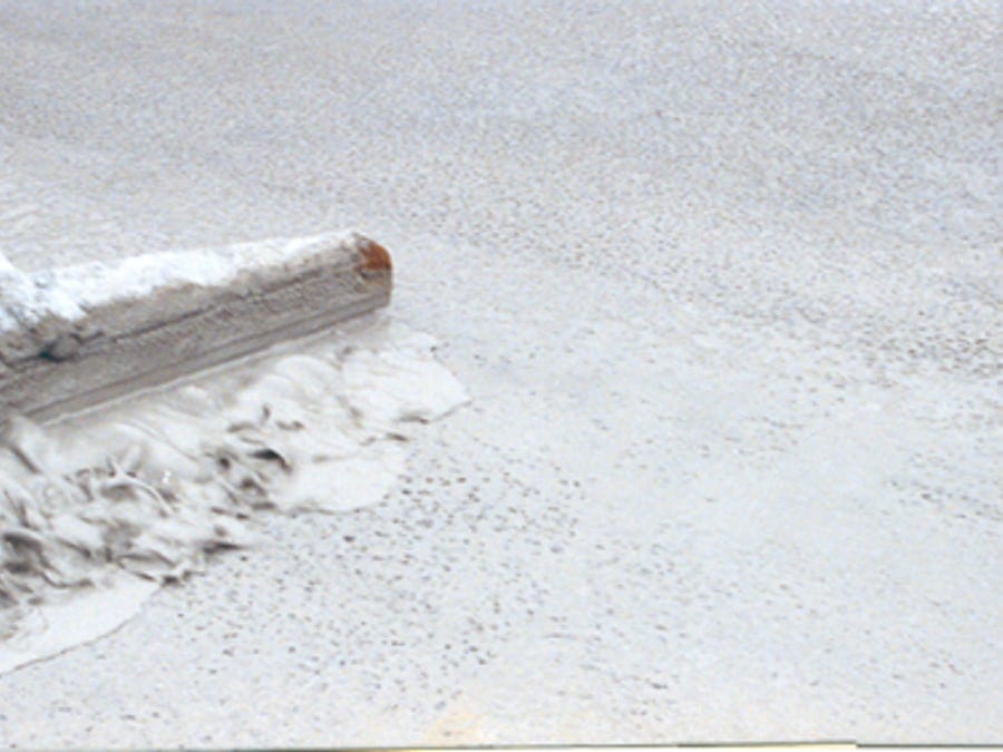 Spreading the mortar across the open graded asphalt